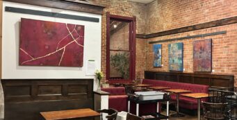 Cafe with abstract colorful paintings on brick walls
